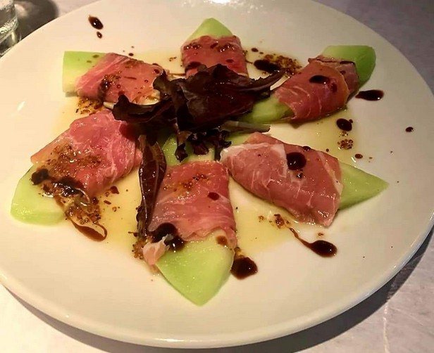 Prosciutto-wrapped melon with balsamic glaze