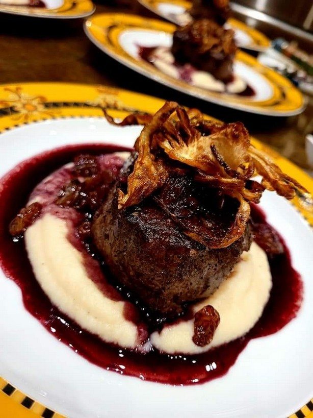 Seared protein, mashed potato and dark sauce with crispy onions