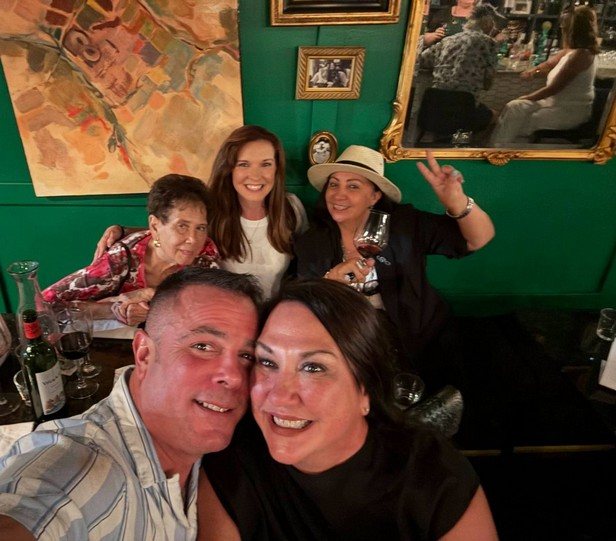 Guests gathered with wine glasses inside Jordan's Wine Bar